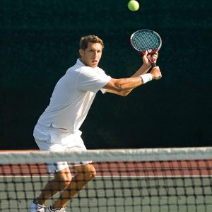 Tennis Player Swinging at Ball