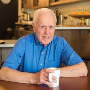 Closeup of Dan Haller with a cup of coffee in his hand