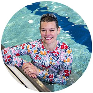 woman in swimming pool with long sleeve flower shirt