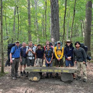 scouts with camping gear in woods