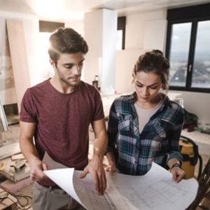 man and woman look at architectural plans