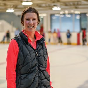 woman with black vest at skating rink