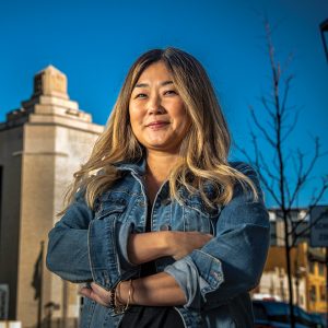 woman with jean jacket and long hair smiles