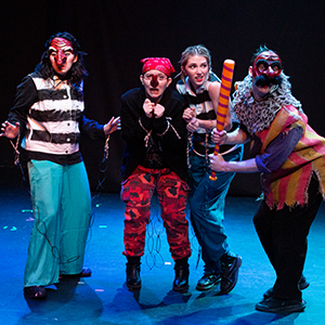 four actors in costume on stage