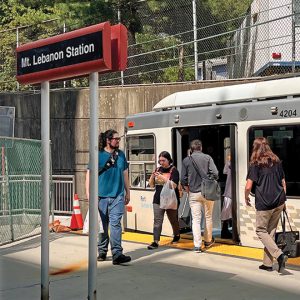 subway train with people entering and exiting on platform