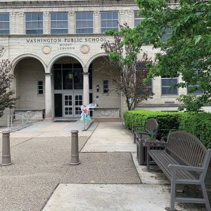 front of elementary school with benches and greenery
