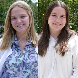 headshot of two women smiling outdoors with greenery