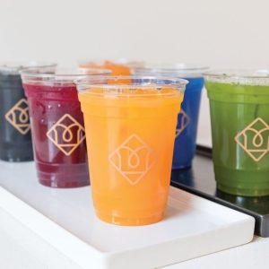 colorful iced drinks in plastic cups