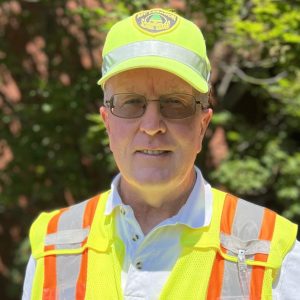 man in yellow vest smiling