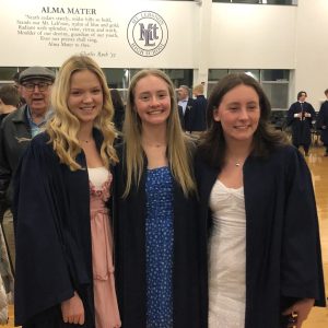 three teens at graduation