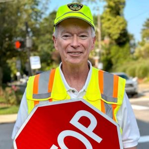 man in yellow vest smiling