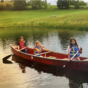 three girls in red canoe