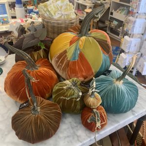 colorful pumpkin decorations, blue, yellow, orange green and brown, on a marble table