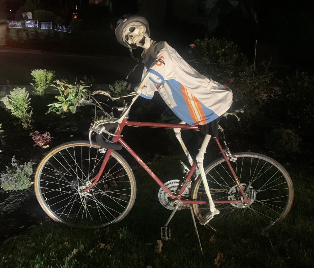 a skeleton Halloween decoration riding a bike
