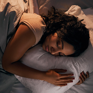 High angle shot of a beautiful young woman sleeping in her bed at home during the night