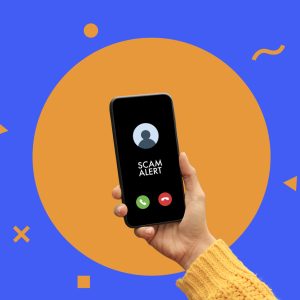 Woman holding phone with scam alert