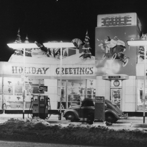 black and white photo of an old gas station that says holiday greetings