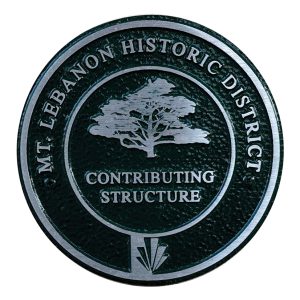 A Mt. Lebanon historic district medallion, showing a tree over the words "contributing structure" on top of the Mt. Lebanon Municipality logo.