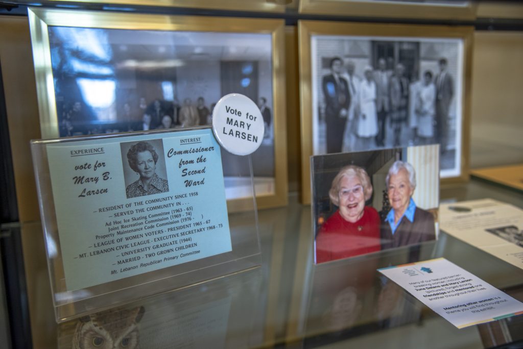 photos and historical artifacts in a glass case