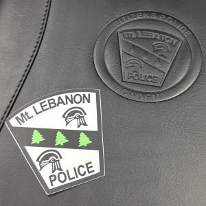 a black leather folder with a black and white sticker with the Mt. Lebanon Police logo