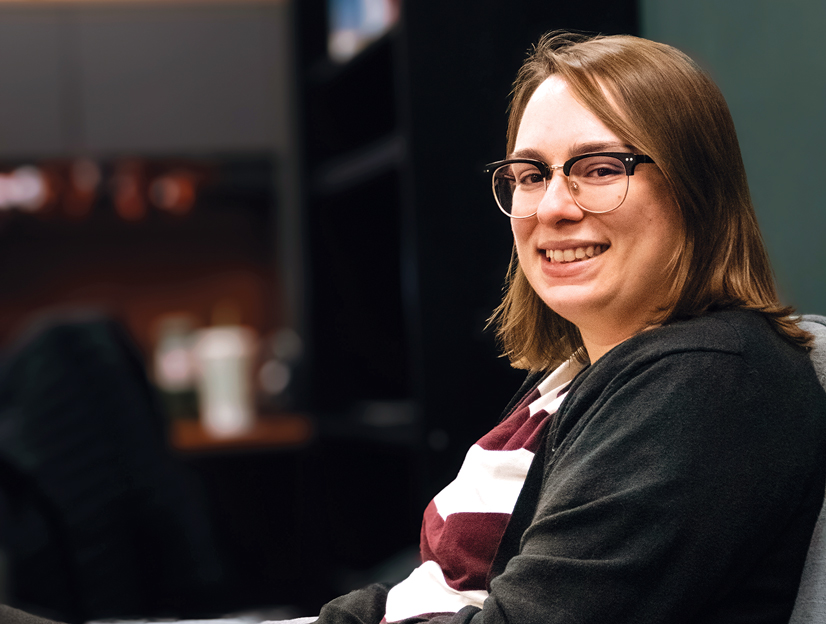 A woman with brown hair and glasses smiling