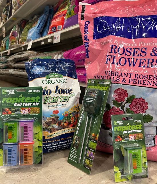 garden products, a pink bag and several packages, in a hardware store