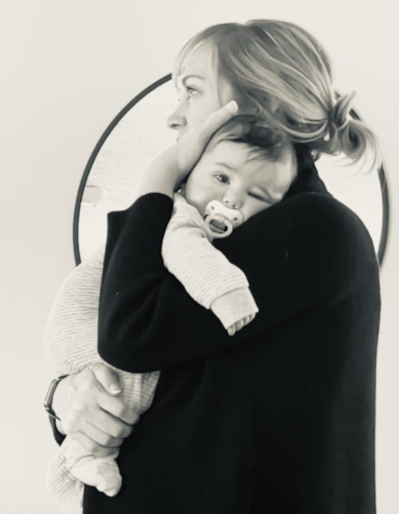 black and white photo of woman holding baby