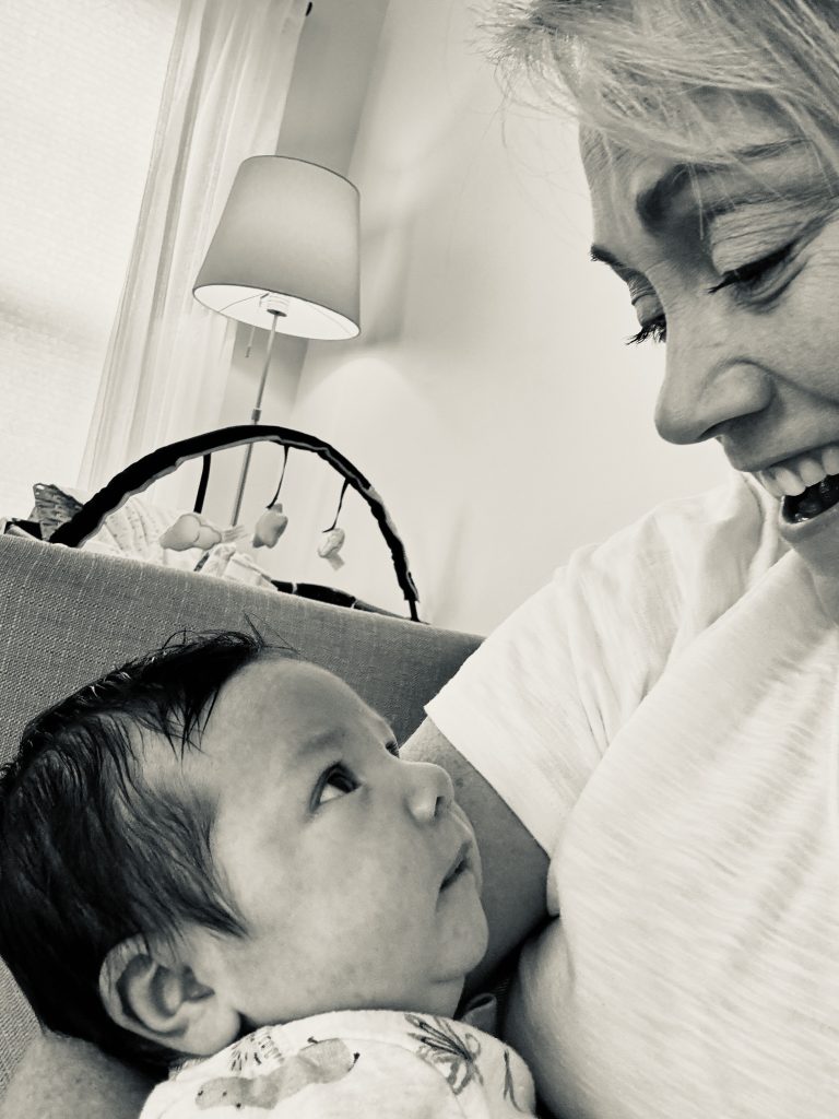 black and white photo of woman holding baby