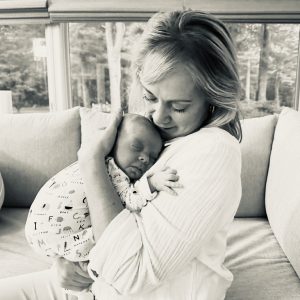 black and white photo of woman holding baby