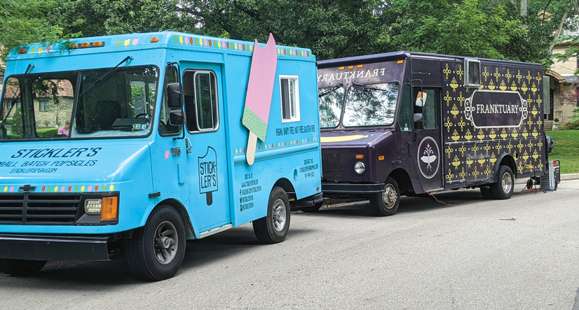 Two food trucks parked next to each other; Sticklers popsicles, and Franktuary