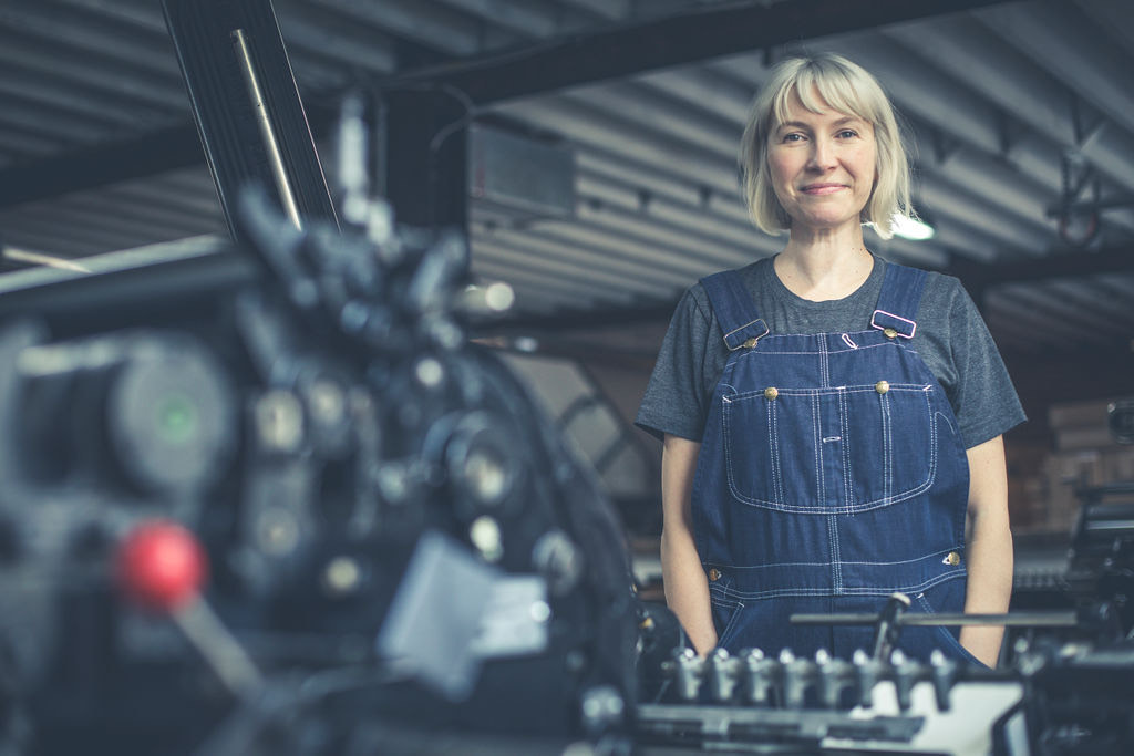 Woman in front of printing press