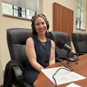 Ella Magaw with headphones on in front of a microphone.