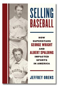 Book cover of "Selling Baseball" by Jeffrey Orens features a black and white vintage photo of two men in "Boston" jerseys, a think red stripe on the left side and the title of the book and authors name in bold text in red and blue.