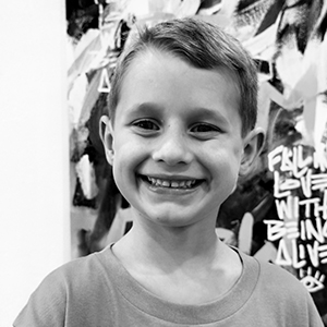 black and white photo of young boy smiling