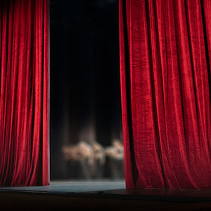 red curtain opening on a stage