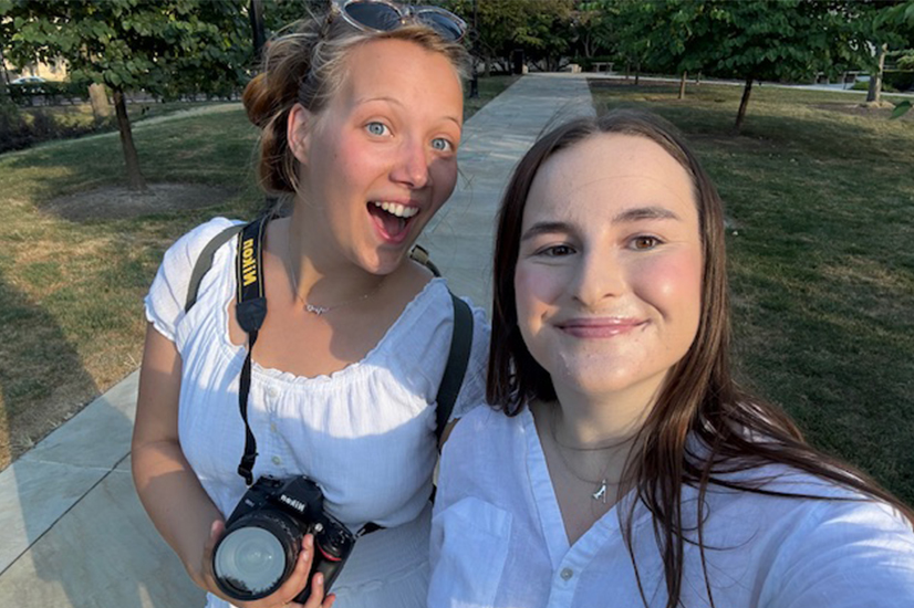 two young women in white shirts taking selfie