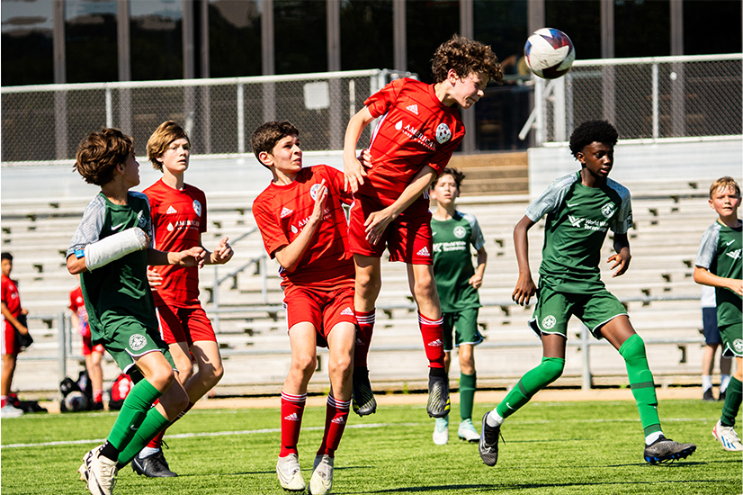 soccer players in red and green uniforms