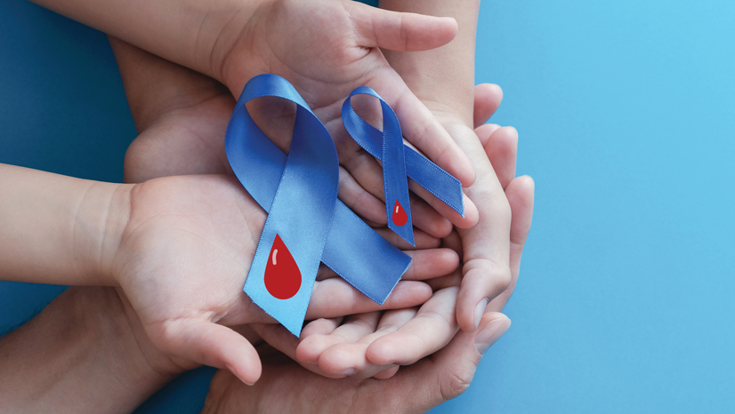 Above view of large hands, holding small hands that are holding two blue ribbons with a blood droplet graphic on it.