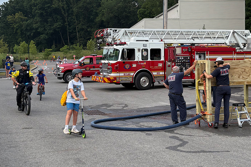 kids riding bikes with firefighters and police