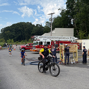 kids and a police officer riding on bikes