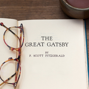the great gatsby book open with glasses