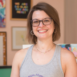 woman smiling with glasses and short hair