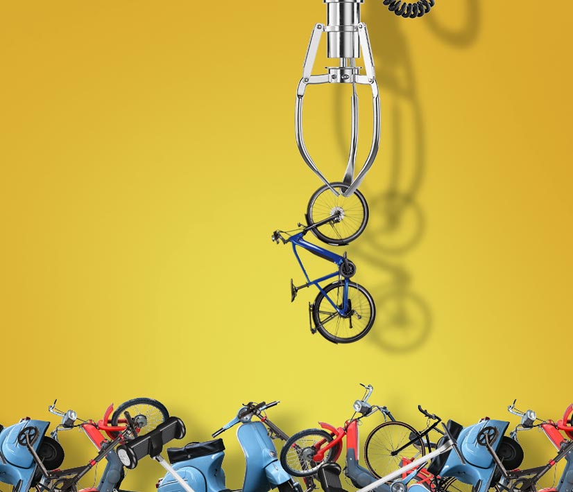 a depiction of a crane game, a crane picking up a bike out of a bunch of different types of bikes piled at the bottom