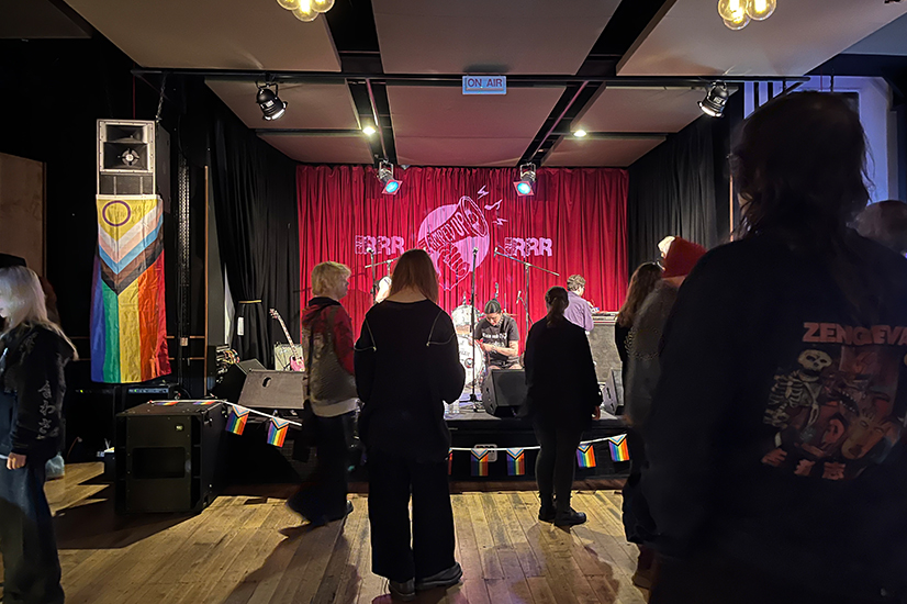 indoor concert venue with band setting up