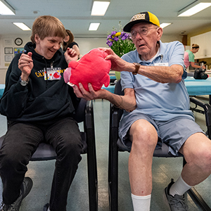 older adults sitting in a circle playing games