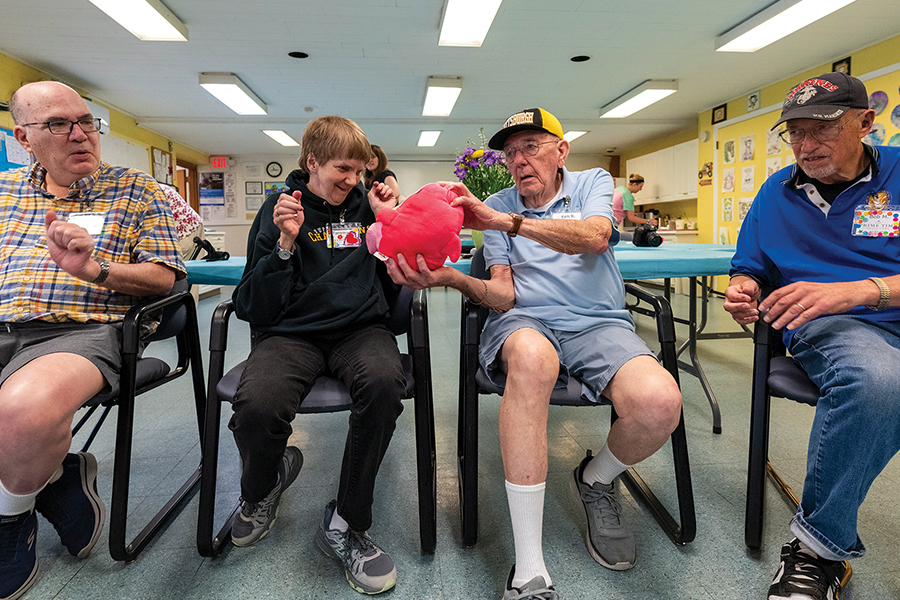 older adults sitting in a circle playing games