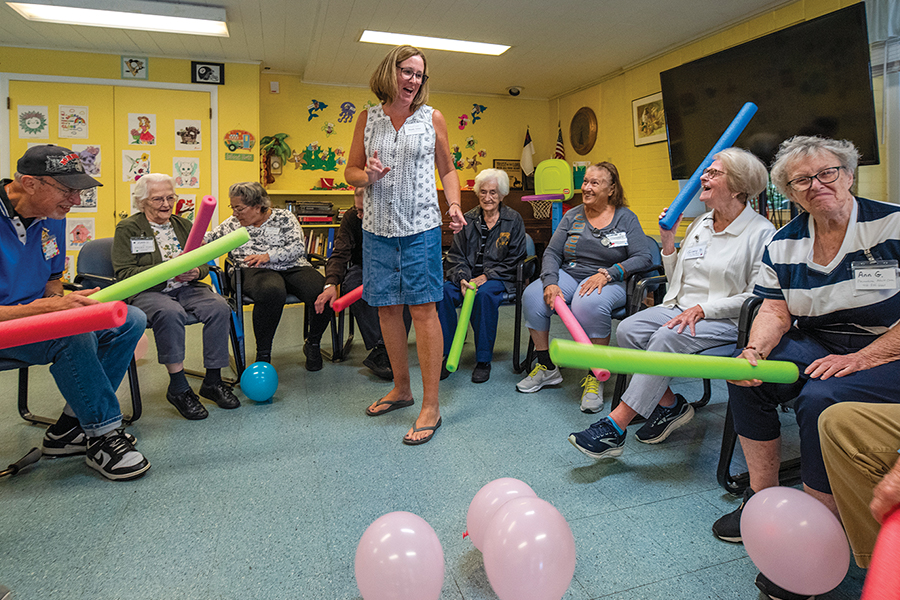 older adults sitting in a circle playing games