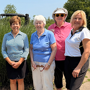 four older women on a golf course