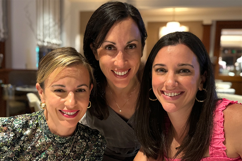 three women smiling in a resturant