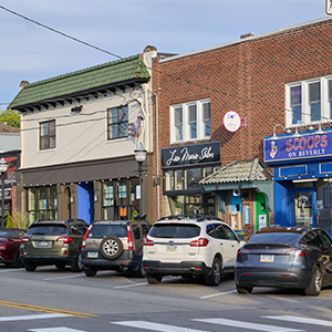 street with parked cars and storefronts